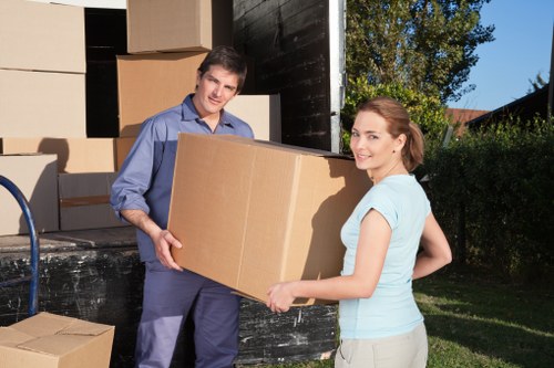 Person using safe manual handling techniques near storage items